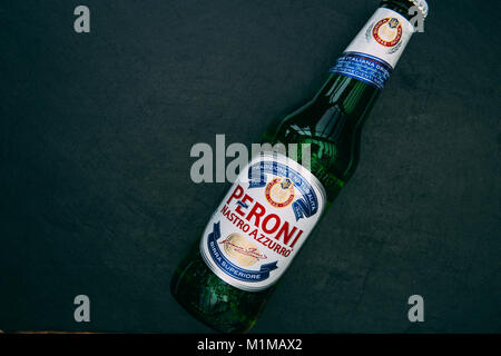LONDON - JANUARY 29, 2018: Peroni lager beer in glass bottle on dark background Stock Photo
