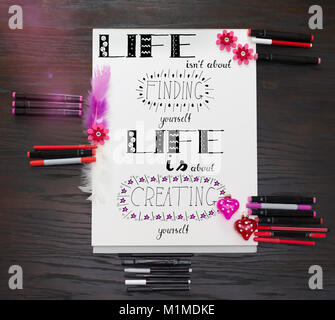 Hand lettering - A motto about life, drawn by hand, in pink and red decoration elements Stock Photo