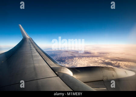 View above the clouds from an airplane during the flight Stock Photo
