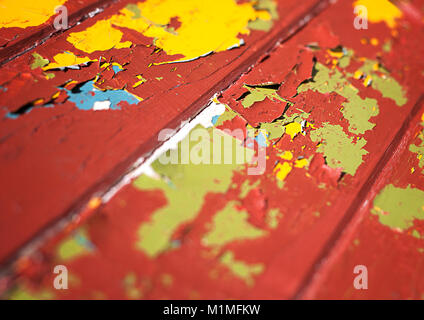 Old peeling paint revealing different layers of coloured paint on wooden surface Stock Photo