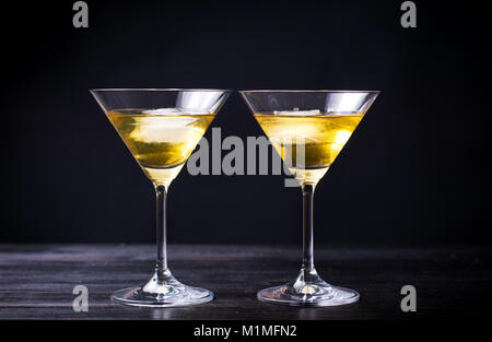 Two martini cocktails on a table against black background Stock Photo