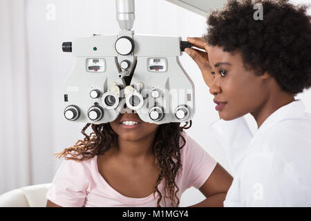 Female African Optometrist Doing Sight Testing For Patient In Hospital Stock Photo