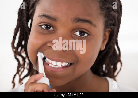 Portrait Of An African Girl Brushing Her Teeth Stock Photo