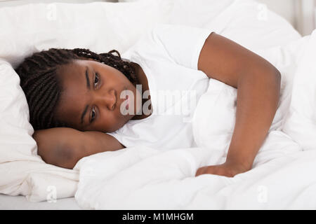 Girl Having Sleeplessness Night In Bed At Home Stock Photo