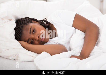 Girl Having Sleeplessness Night In Bed At Home Stock Photo