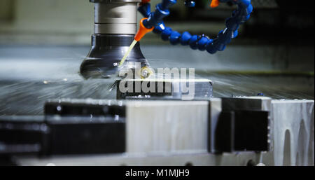 Precision industrial CNC machining of metal detail by mill at factory Stock Photo