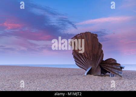 Scallop Shell Sculpture at Sunset with beautiful pink sky on Aldeburgh Beach in Suffolk, England Stock Photo