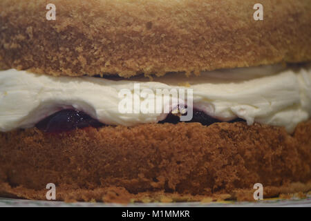 food image of close up home made traditional Victoria sponge cake with butter cream and jam filling Stock Photo