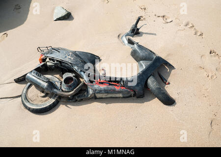 Old scooter covered with sand on a beach in Al Aqah Beach, Fujairah, United Arab Emirates