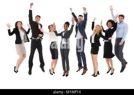 Excited Businesspeople Raising Their Hands While Jumping On White Background Stock Photo