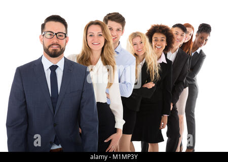 Portrait Of Young Confident Businesspeople Standing In Row Stock Photo