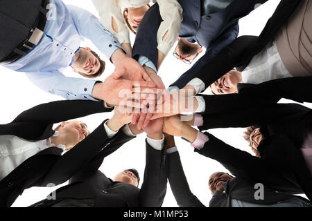 Low Angle View Of Multiracial People Stacking Hands Stock Photo