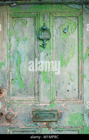 An old wooden door with peeling paint - John Gollop Stock Photo