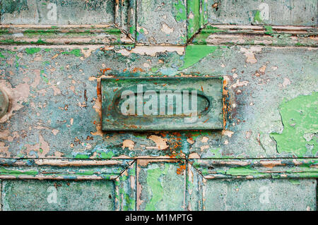 Close-up of an old wooden door with peeling paint and letterbox - John Gollop Stock Photo