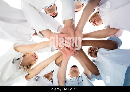 Low Angle View Of Smiling Medical Team Stacking Hands Stock Photo