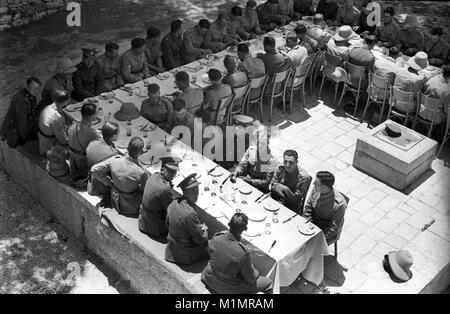 British army soldiers sitting down for lunch in Palestine 1940 Stock Photo