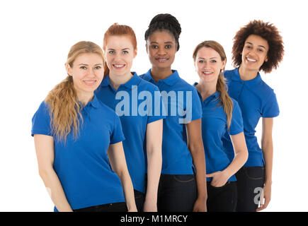 Group Of Young Female Janitors Standing In Row Against White Background Stock Photo