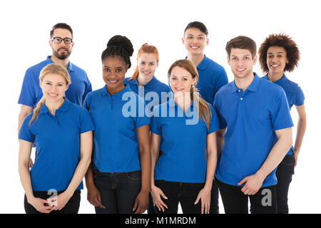 Portrait Of Happy Multiracial Janitors In Front Of White Background Stock Photo