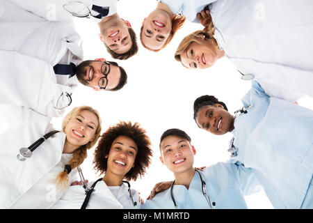 Low Angle View Of Happy Medical Team Forming Huddle Stock Photo
