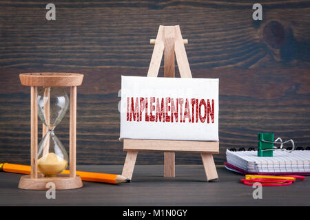 Implementation. Sandglass, hourglass or egg timer on wooden table Stock Photo