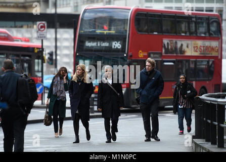 Mayor of London Sadiq Khan (centre) arrives at a bus stop at Elephant and Castle in south London as he prepares to take the bus to City Hall to mark the first day of the unlimited Hopper fare, which allows passengers to make unlimited bus and tram journeys in a one-hour window for one fare. Stock Photo