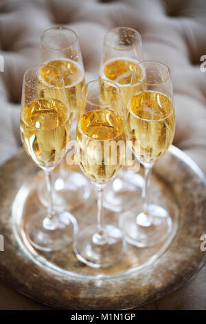Champagne glasses on silver tray. Party and holiday celebration concept Stock Photo