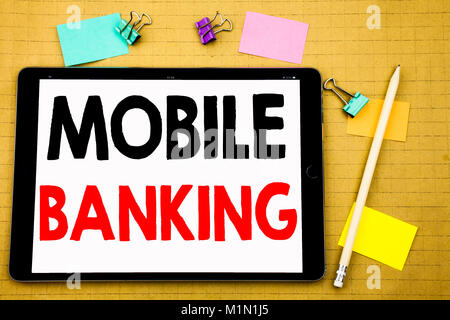 Hand writing text caption inspiration showing Mobile Banking. Business concept for Internet Banking e-bank Written on tablet, wooden background with s Stock Photo