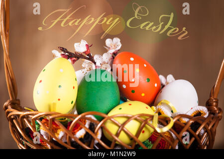 Easter motif, painted Easter eggs in a wooden box. decorated with a branch of white spring branch Stock Photo
