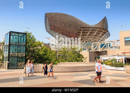 BARCELONA, SPAIN - June 21, 2017 : in the middle of the day, tourists stroll in front of the fish of the American architect Frank Gehry built on the o Stock Photo
