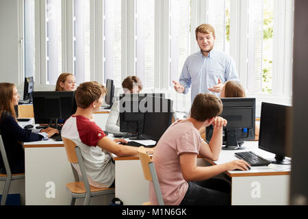 Teenage Students Studying In IT Class With Teacher Stock Photo