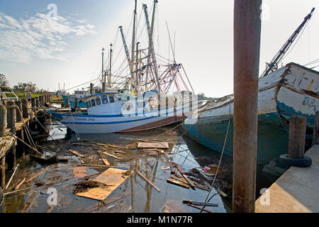 A number of shrimp trawlers crashed into the docks by the waves and storm surge brought on by Hurricane Katrina. The stern of the wooden Vietnamese sh Stock Photo