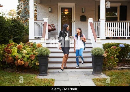 Businesswoman Mother Walking Daughter To School On Way To Work Stock Photo