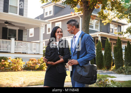 Business Couple With Baby Son Leaving House For Work Stock Photo