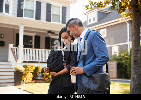 Business Couple With Baby Son Leaving House For Work Stock Photo