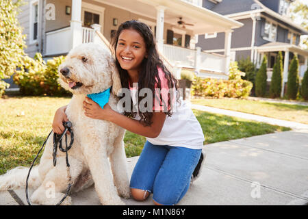 Portrait Of Girl With Dog On Suburban Street Stock Photo
