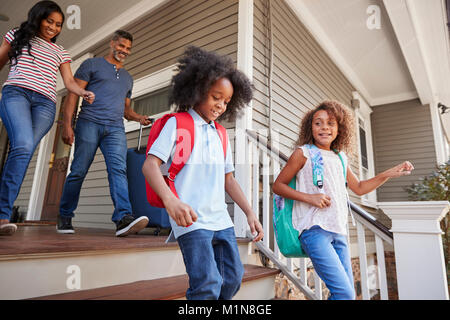 Family With Luggage Leaving House For Vacation Stock Photo