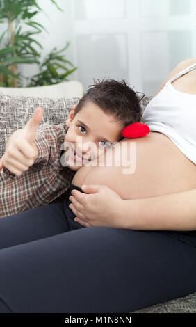 little boy and his pregnant mother spend time together Stock Photo