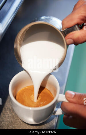 Close Up Of Male Barista Using Coffee Machine In Cafe Stock Photo