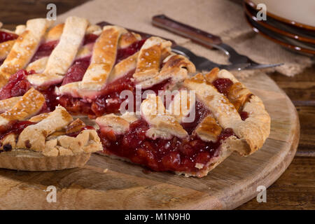 Slice of cherry pie on a wooden platter Stock Photo