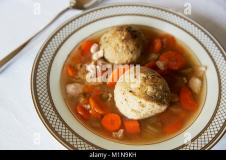 Jewish matzon ball soup served in a dish for passover Stock Photo