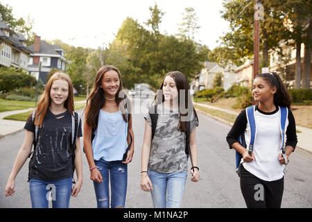 Four young teen girls walking in the road, close up Stock Photo