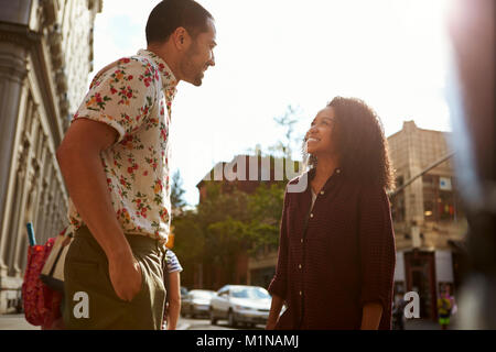 Young Couple Walking Along Urban Street In New York City Stock Photo