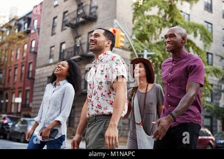 Group Of Friends Walking Along Urban Street In New York City