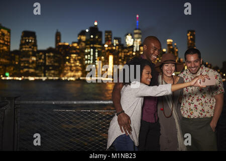 Group Of Friends Posing For Selfie In Front Of Manhattan Skyline Stock Photo