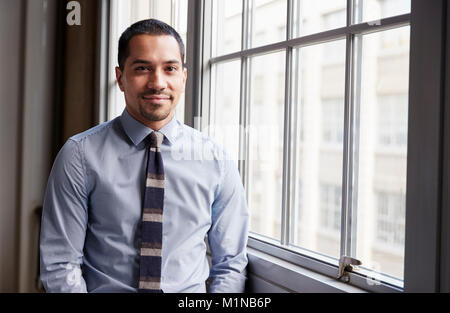 Young Hispanic business man smiling to camera Stock Photo