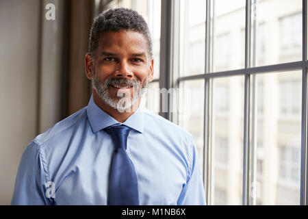 Middle aged black businessman smiling to camera Stock Photo