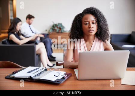 Young black businesswoman using laptop at a desk Stock Photo