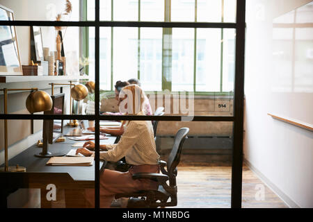Business team working in an office booth, close up Stock Photo