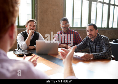 Casually dressed male colleagues at a meeting, close up Stock Photo