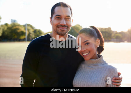 Young couple smiling at camera in Brooklyn, close up Stock Photo